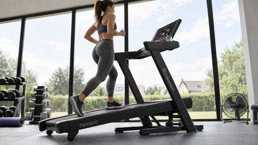 Healthy 40 year old woman with brown hair jogging at incline on her Lifesmart TM4000C treadmill.