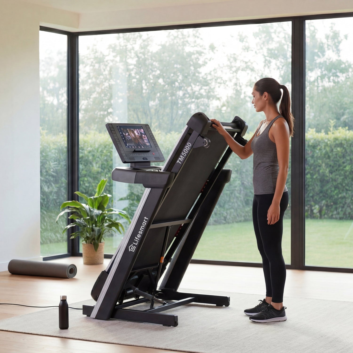 Woman using a Lifesmart TM5000 treadmill in a modern home gym with large windows.